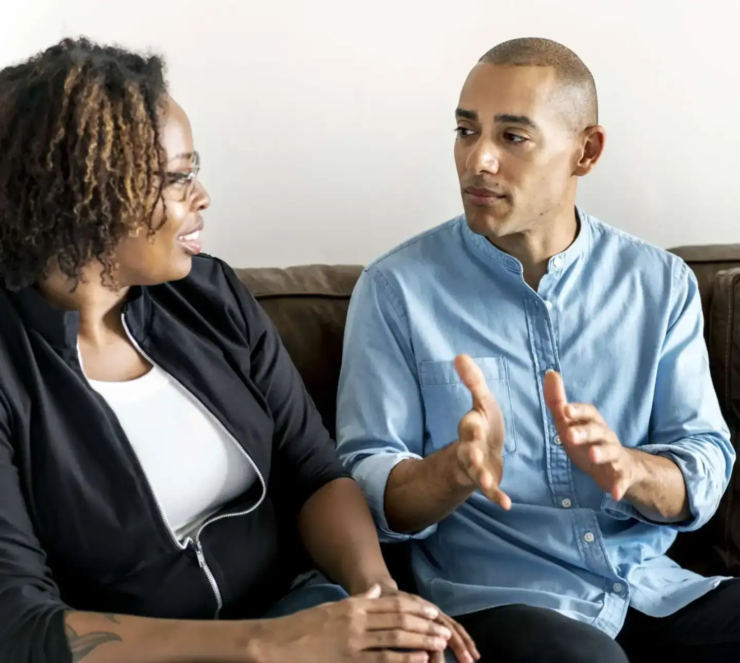 Two adults in conversation during a supportive therapy session.